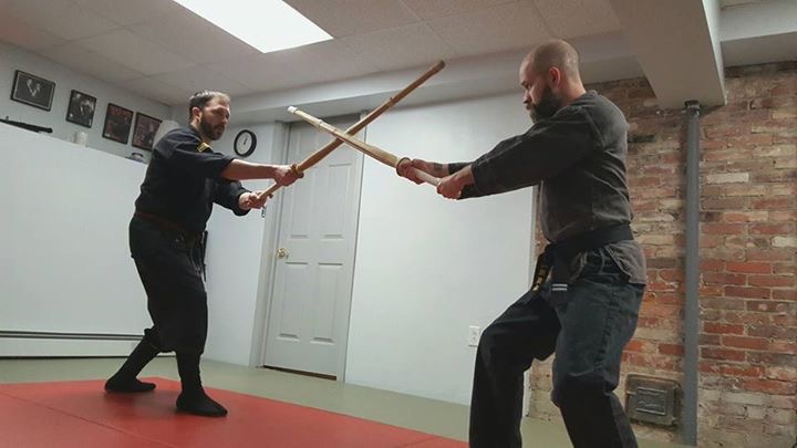 Kevin Levesque, left, doing a sword technique 