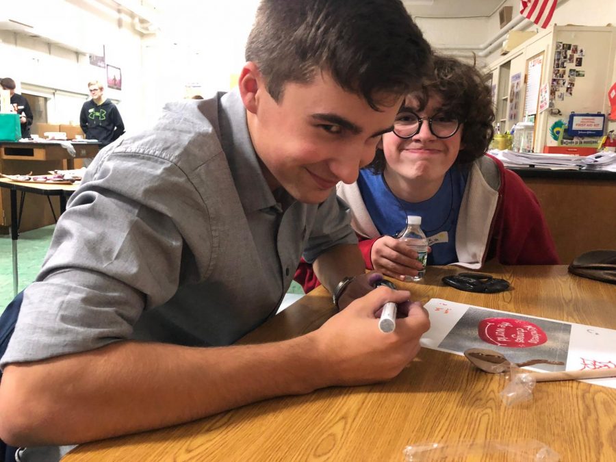 Andre Daigle 19 and Erik Smith 19 paint rocks for the Kindness Rocks Project