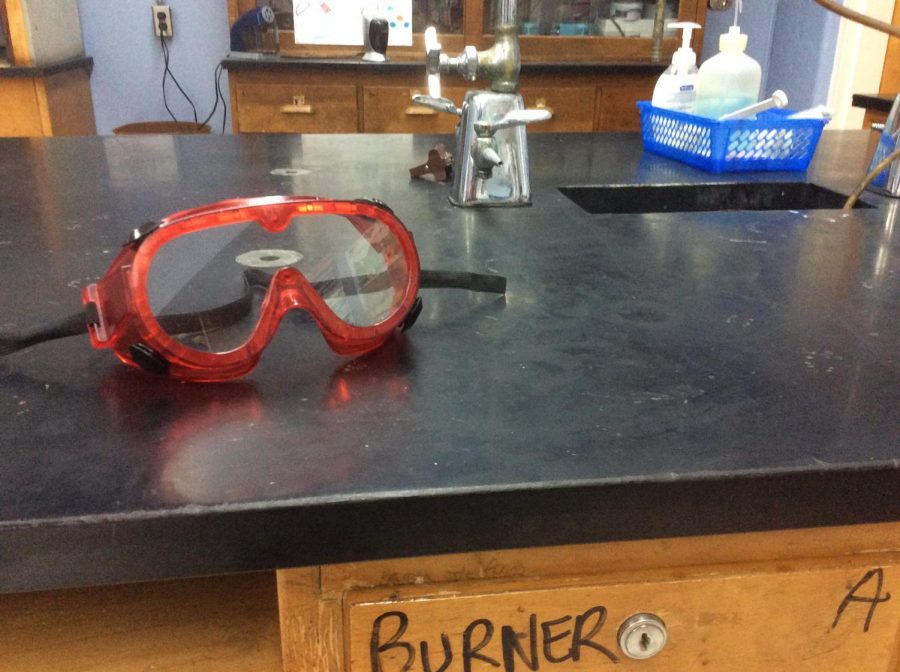 A pair of dyed red goggles sits on the lab table in Ms. Grooms classroom.
