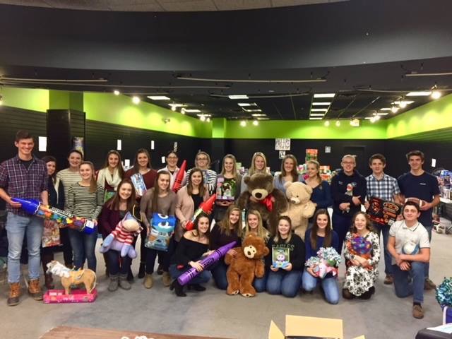 PIHS Varsity Club members organize toys at the Aroostook Centre Mall on December 12.