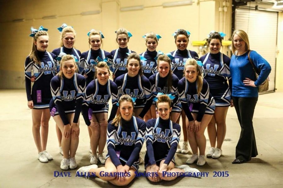 PIHS cheerleaders take their last photo in their navy uniforms at the state basketball game.