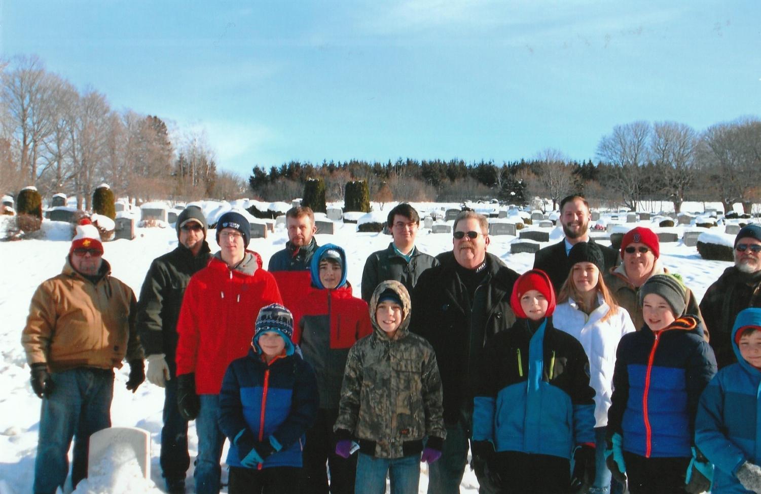 Volunteers line up in front of the gravestones at Fairmount cemetary. They honored 60 veterans with donated wreaths that day.