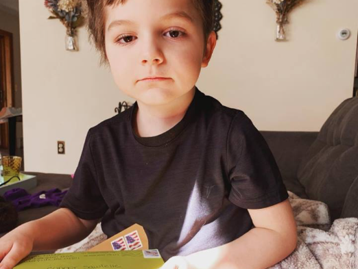 Six year-old Connor Sawtelle of Augusta sits with some of the cards of encouragement people have sent. Connor has received over 1,000 cards, according to his mother, Erika Sawtelle. “I am so thankful for our community and everyone who has sent a card,” she said. “We are slowly working our way through the huge pile. But I cherish every card sent!” 