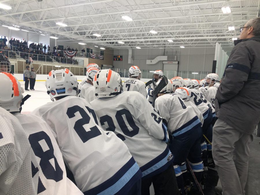 Wildcat hockey players discuss strategy in a timeout during the inaugural preseason tournament at PCIA. Players added orange tape to their helmets in recognition of recently deceased Brewer hockey player, Jordan Parkhurst.