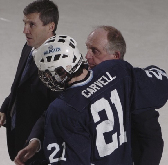 Former assistant John Haley talks to senior Mark Carvell during a 2009 game. “John was an ambassador for our sport and for the County,” said head coach Carl Flynn.