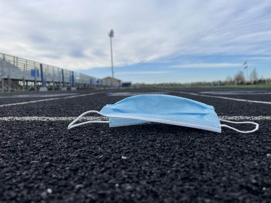 A mask lays discarded on the track at the Gehrig Johnson Athletic Complex in Presque Isle.