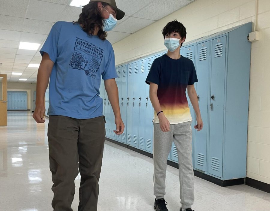Chase Guerrette 22 and Reagan Salcedo 25 walk the halls on September 3, a few days after the return of the mask mandate. I think everyones in the same boat that we would prefer not to wear them, said Libby Kinney 22. But we are doing whats needed.