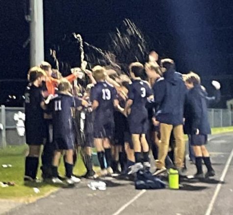 Boys varsity soccer team celebrates after win against MDI in the quarterfinal game on October 26.