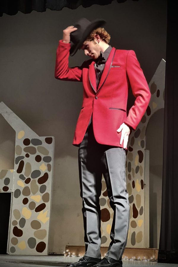 Jack Hallett ‘23 models a red tux to the crowd during the senior fashion show on October 18.