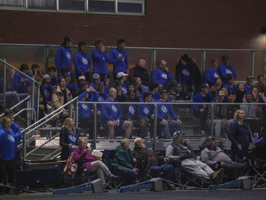 Members of the UMPI mens and womens soccer teams help pack the stands on Tuesday, October 25 as the PIHS girls varsity soccer team competed in the quarterfinal against Ellsworth. Both UMPI boys and girls soccer teams showed their support at the game by wearing their Aaron shirts. 