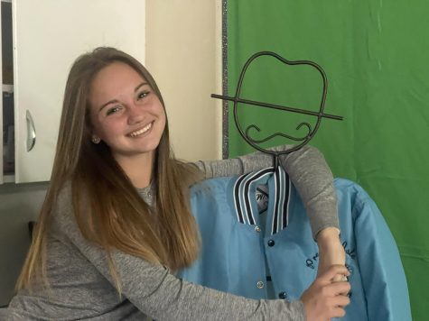 Astra poses in the journalism classroom