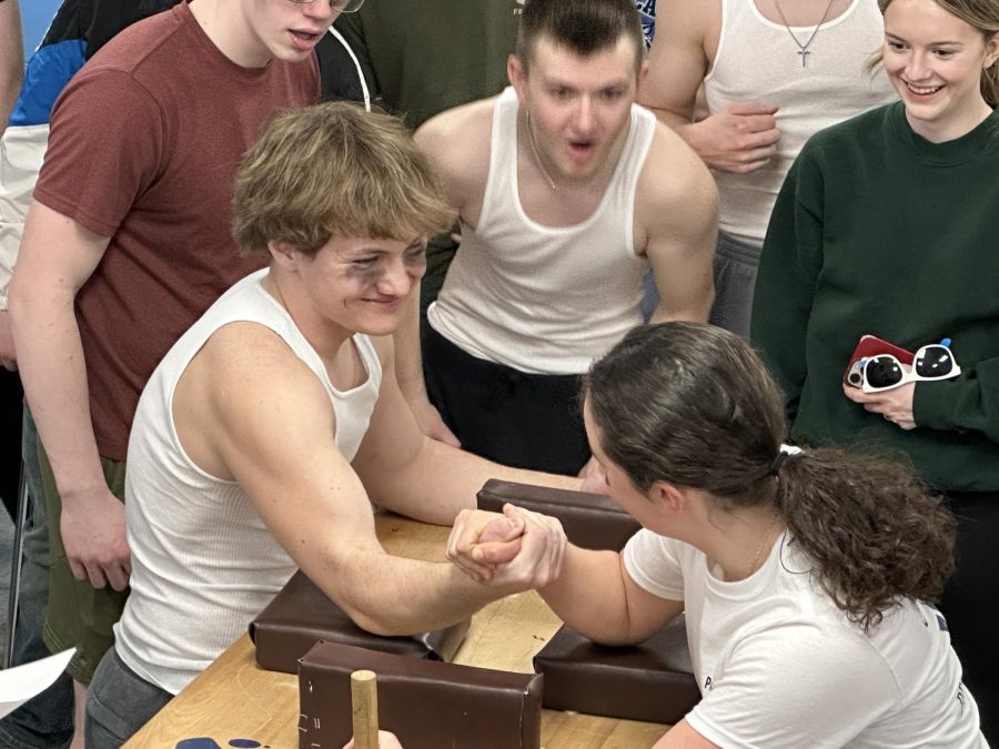 Gavin Tawfall ’23 grins before he takes the victory in arm wrestling over Aubrey Ellsworth 26.