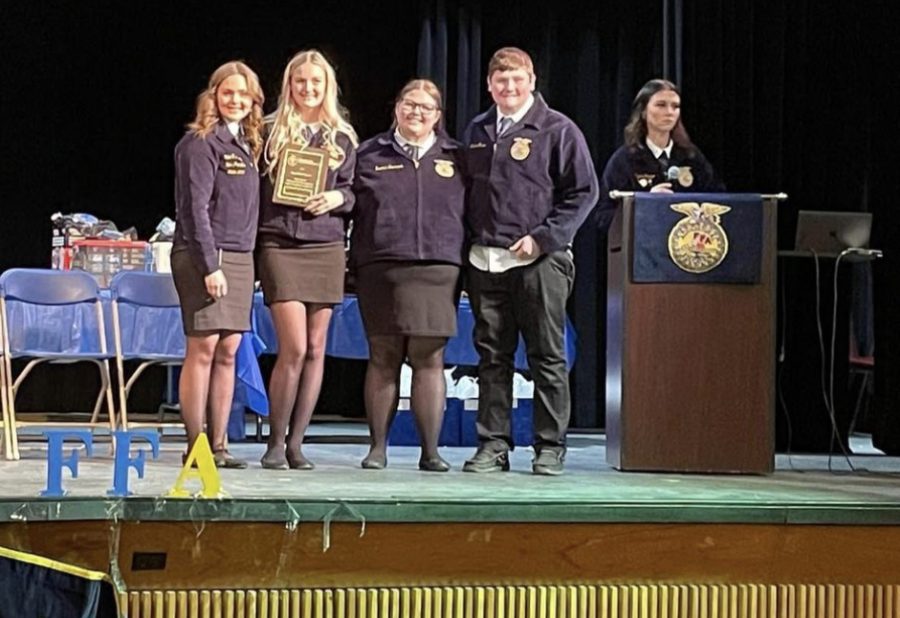 The Dairy Cattle Evaluation team receives their plaque from FFA State President Nickie Deschaine.