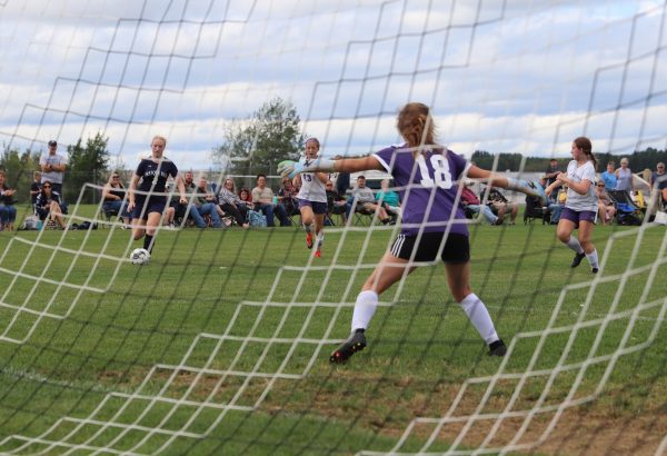 Feel the pressure! Sabine Wells-Puckett ’27 attempts to make a goal while the Bapst goalie stands in her way. The Presque Isle JV girls team won 2-0. “It was a decently easy win, but we should’ve scored more with the way they were playing,.” Maddy Brazier ’26 said. 
