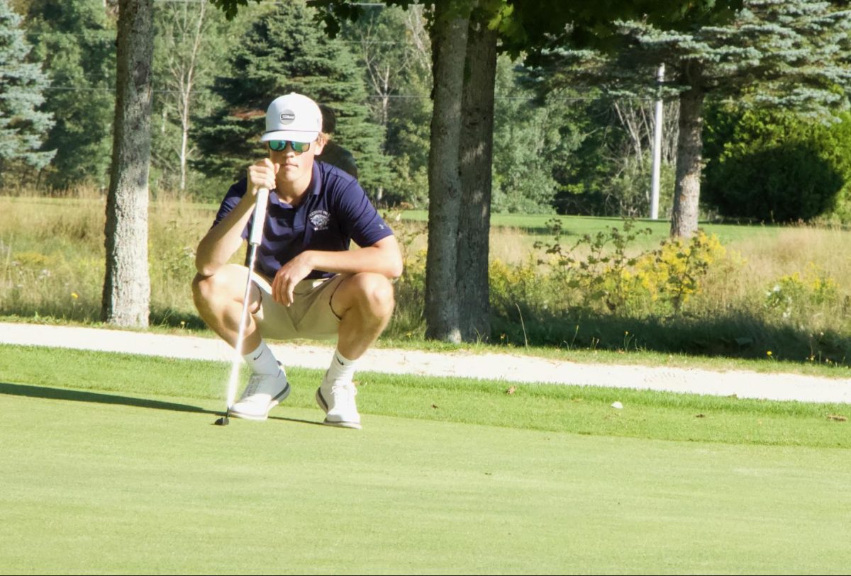 Read the green. Jack Boone sizes up a putt on hole 8, on Monday, August 28 at PICC. Boone shot a 39 in second in the match and went on to medal the next match against Bangor Muni on Thursday, August 31. “I was tired of sucking at golf, so now I go low,” Jack Boone ’24 said.
