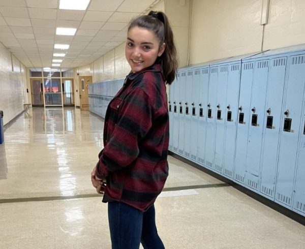 Pose for the picture. Mia Arcott ’26 was full of smiles as she traveled the halls during the November 15 dress up day. “I had to take my grandpas flannel because I don’t even have one,” Arcott said.

