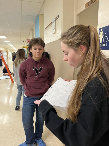 Keira Tompkins ‘26 and Evan St. Peter ‘26 discuss plans for the Deck the Hall themes. 

