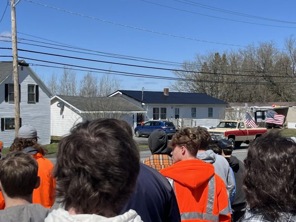 Just rolling by. PIHS students watch as the memorial parade is held for Wesley Coty on April 25. “I think it was cool how they got different companies to come out, and orange was his favorite color, so it was a good way to commemorate him,” Karter Poisson ‘27 said. The parade passed by the high school at 1:00 and students watched for about 30 minutes.

