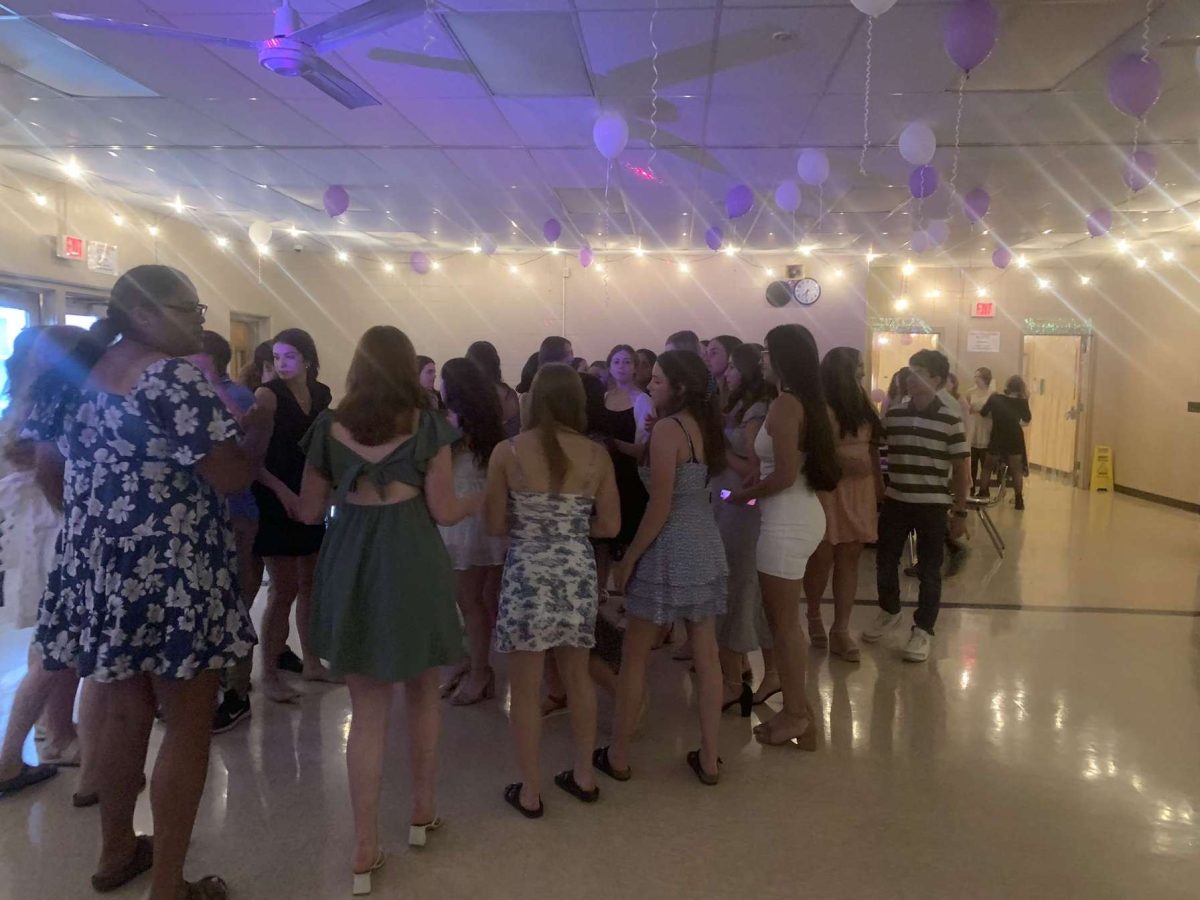 Lost under the lights. Class of 2026 and the eighth graders enjoy their night at the step up dance on May 31 in the PIHS cafeteria.

